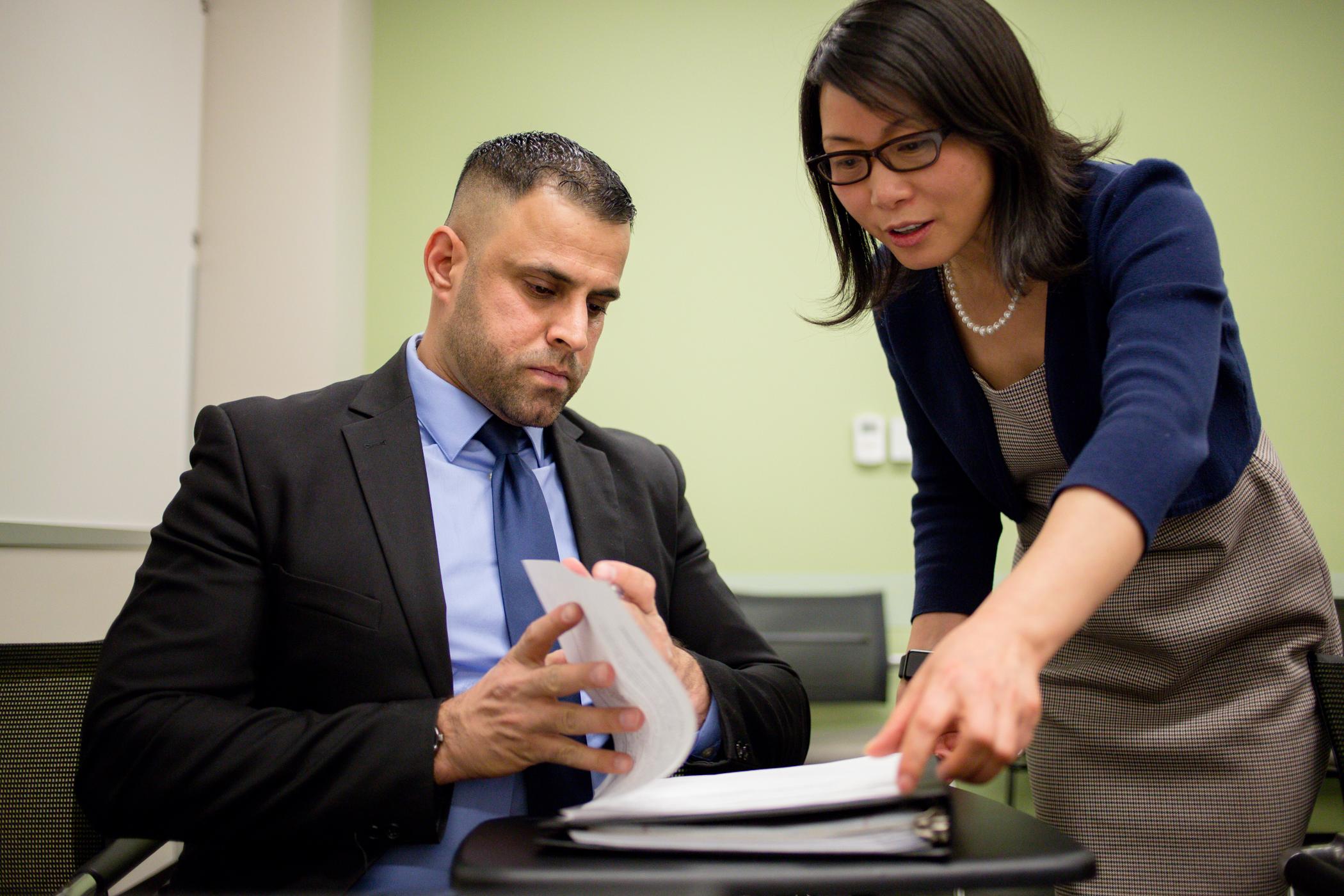 Female reviewing documents of a male